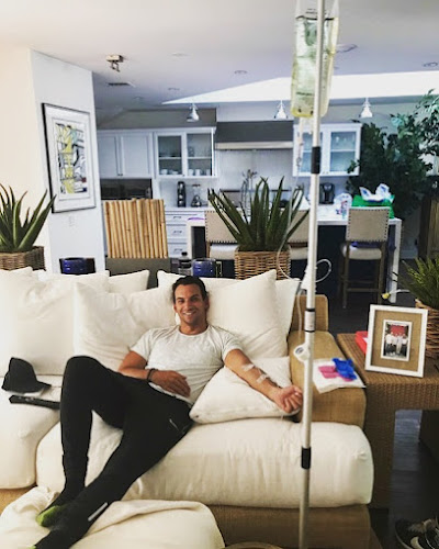 Man receiving IV therapy at home from Drip IV Therapy.