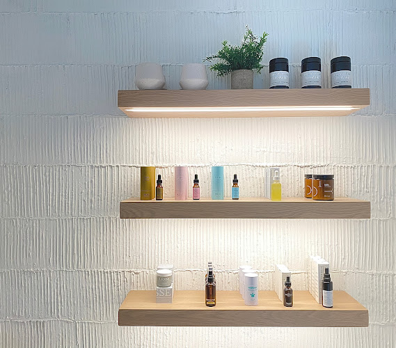 Lume IV therapy wellness products displayed on modern wooden shelves.