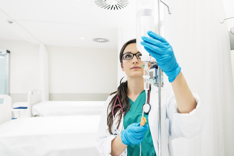 Nurse preparing IV drip at Smart Choice Infusion and IV Therapy.